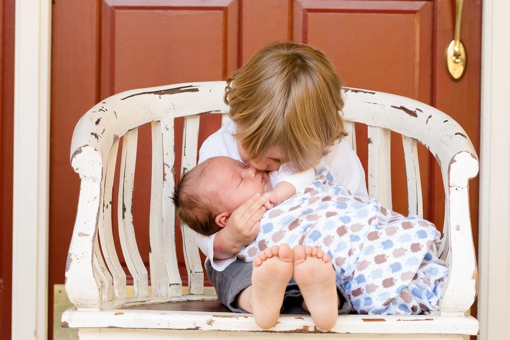 Boy holding baby