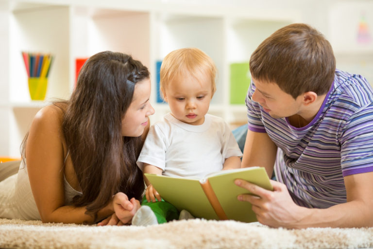 Parents reading with baby