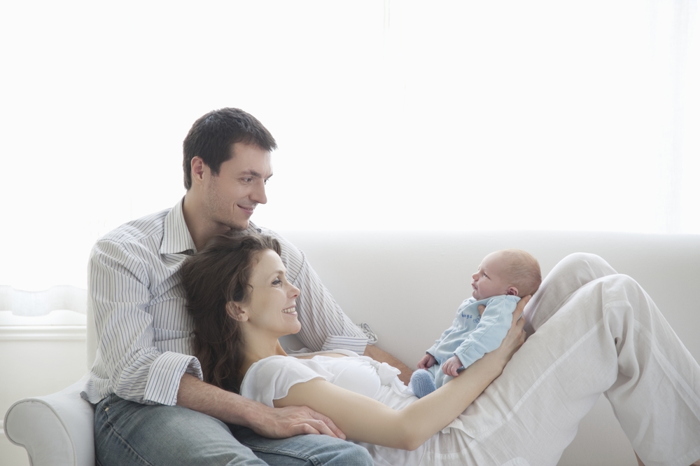 Parents with newborn on couch