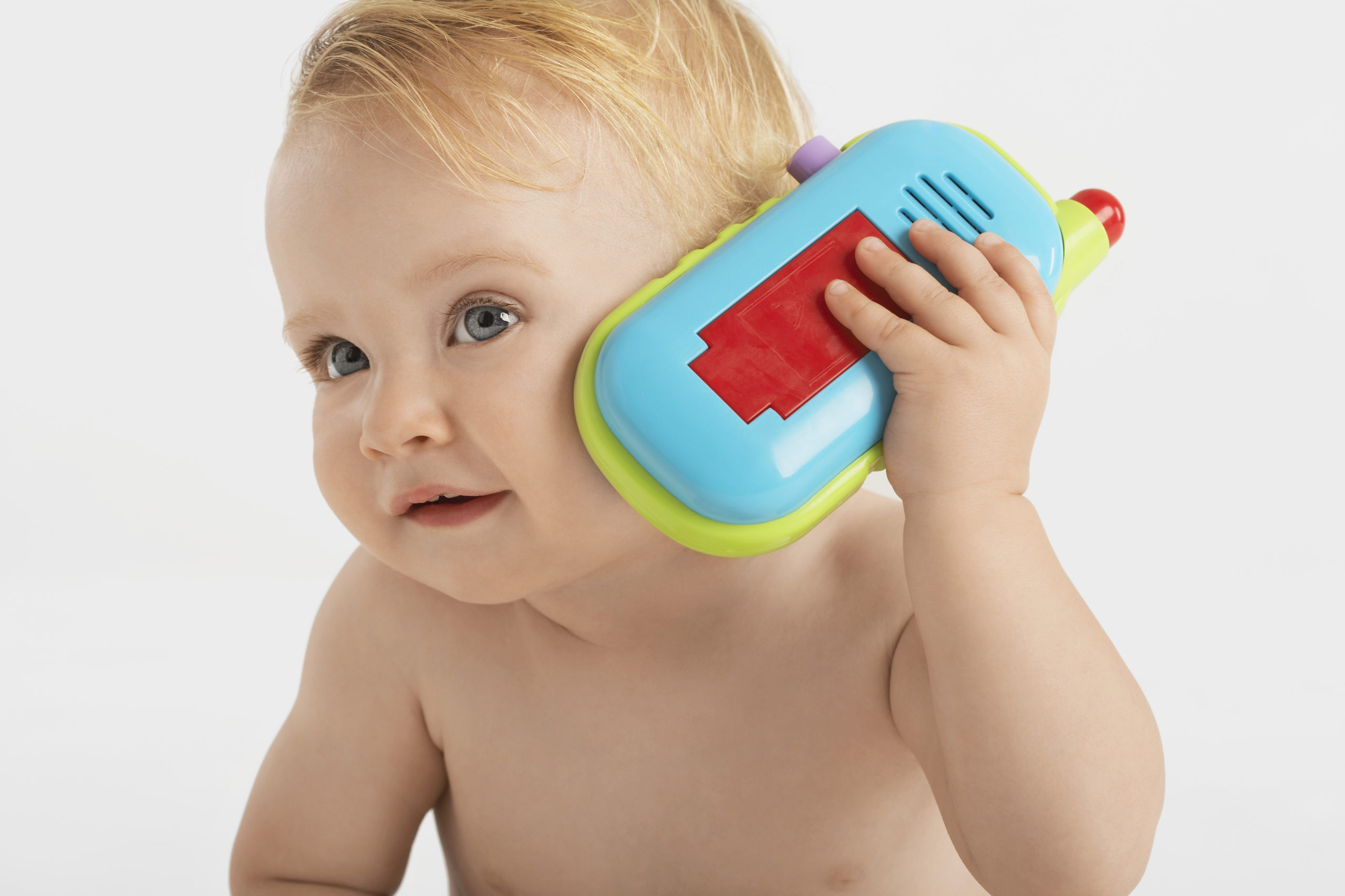 baby with toy phone