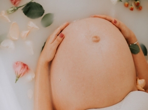 Pregnant stomach in bath