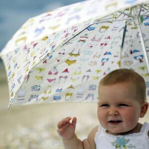 Baby on beach under umbrella